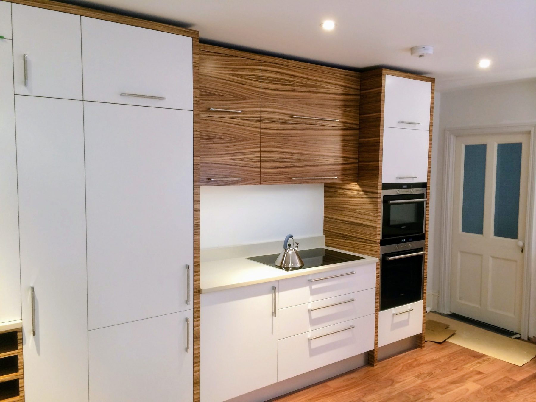 Bespoke contemporary kitchen in pure white and zebrano wood